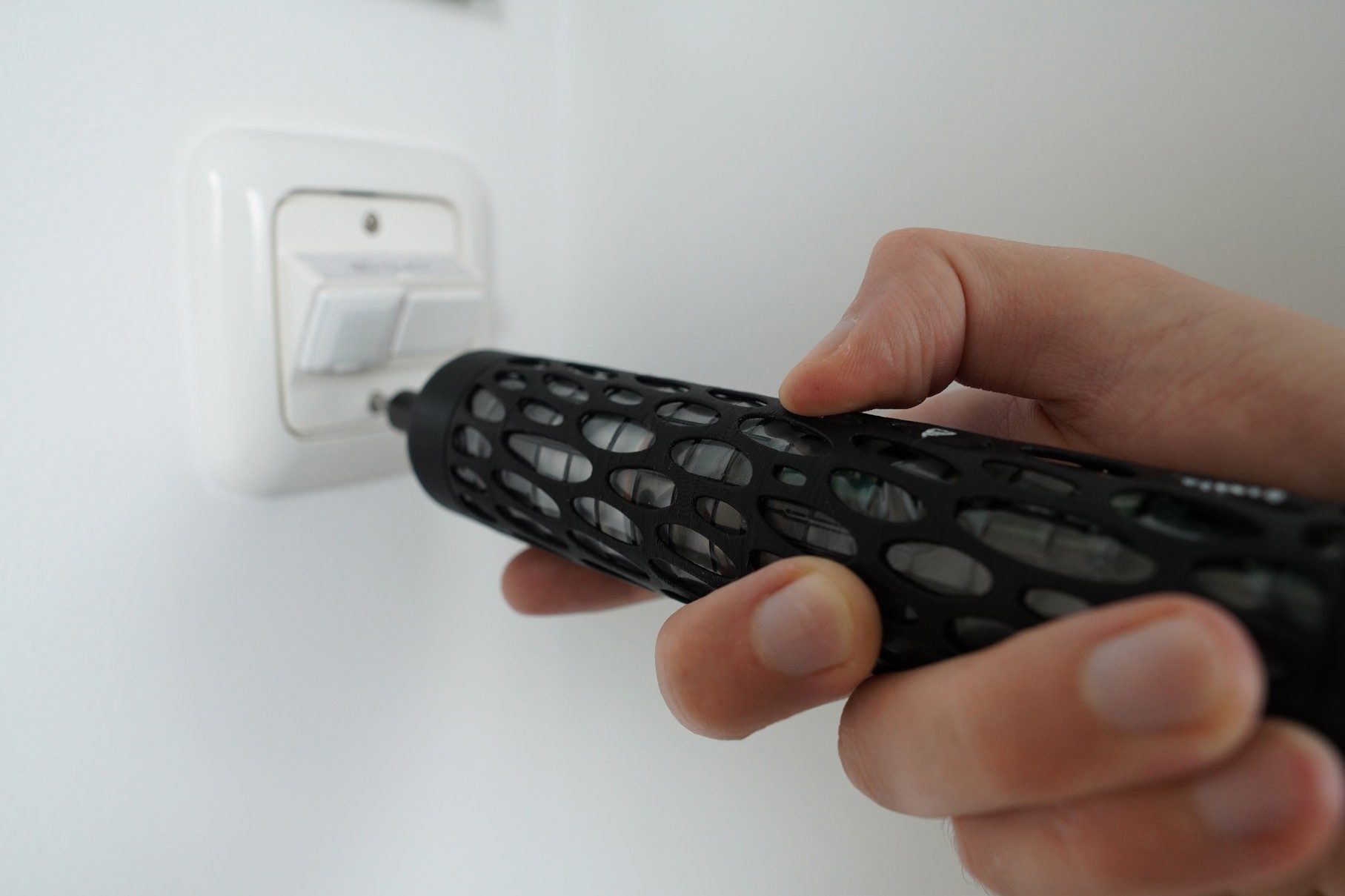 Prototype in use on a light switch